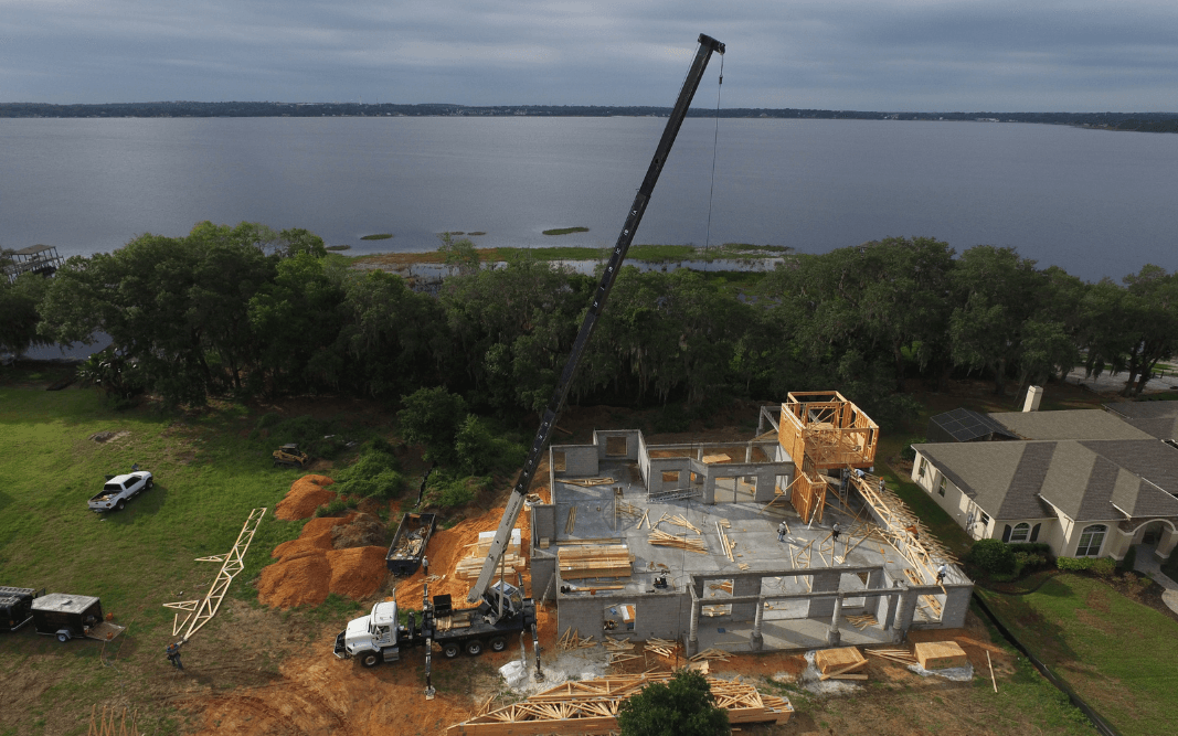 Residential and commercial construction site near a lake, showing Bridgethorn Construction’s range of services in the greater Clermont, FL area.