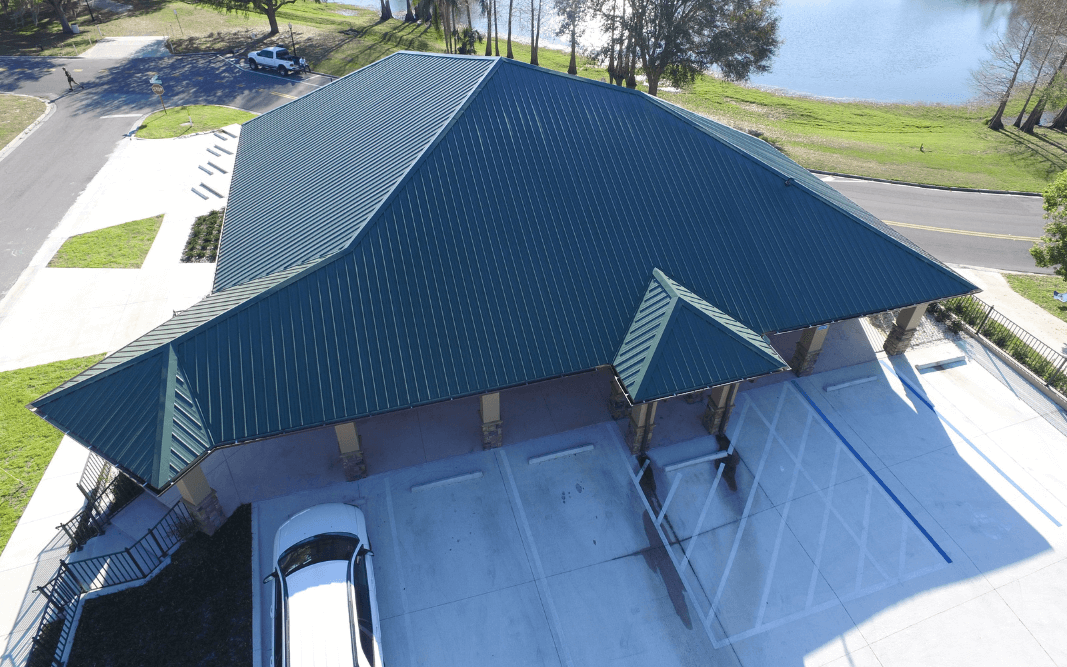 Aerial view of a finished commercial building with green metal roofing in Clermont, FL, representing Bridgethorn Construction’s service across Central Florida.