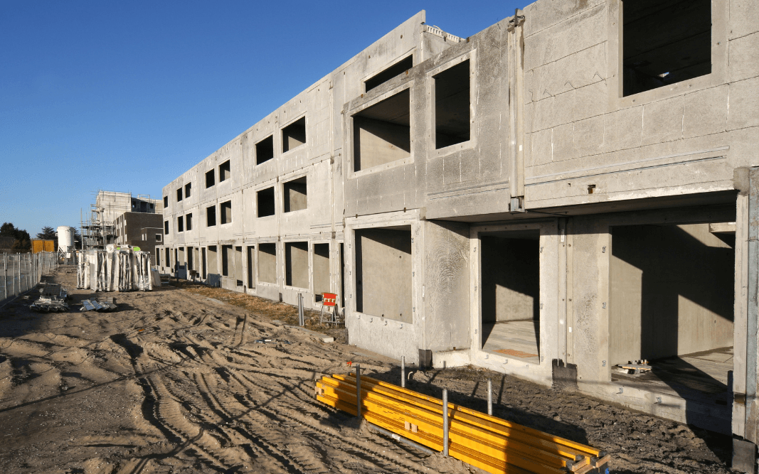 Concrete structure of a multi-family apartment building under construction in Clermont, FL, showing project timeline stages by Bridgethorn Construction.