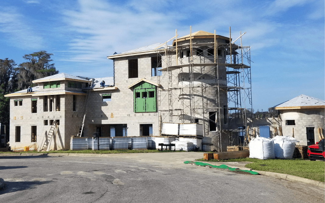 Multi-story custom building under construction in Clermont, FL, with scaffolding and masonry work, illustrating Bridgethorn Construction’s expertise in large-scale projects.