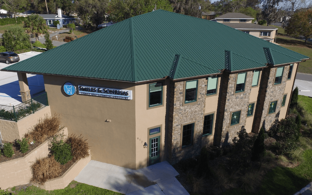 Completed custom commercial office building in Clermont, FL, by Bridgethorn Construction, featuring a modern design with a green metal roof.