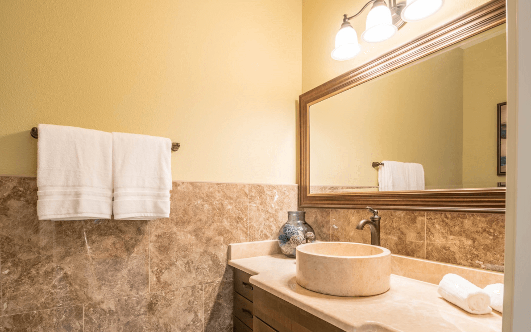 Modern bathroom with custom stone finishes in a multi-family residential unit in Clermont, FL, by Bridgethorn Construction, offering tenant customization options.