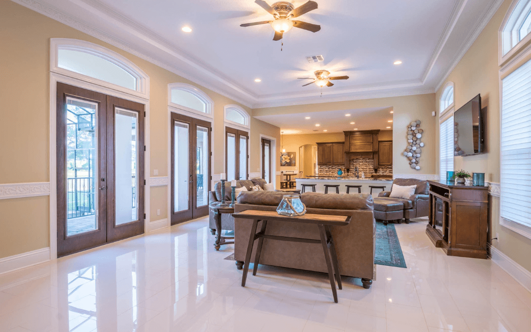 Spacious custom living room with open layout, high ceilings, and luxury finishes in a Clermont, FL home by Bridgethorn Construction, featuring specialty room customization.