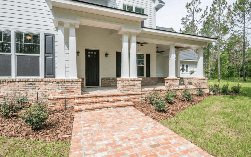 Brick entryway and covered front porch of a custom-built home in Clermont, FL, by Bridgethorn Construction, serving Central Florida.