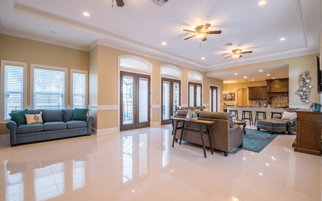 Open-plan living room with high ceilings and natural light in a custom-built Clermont, FL home by Bridgethorn Construction.