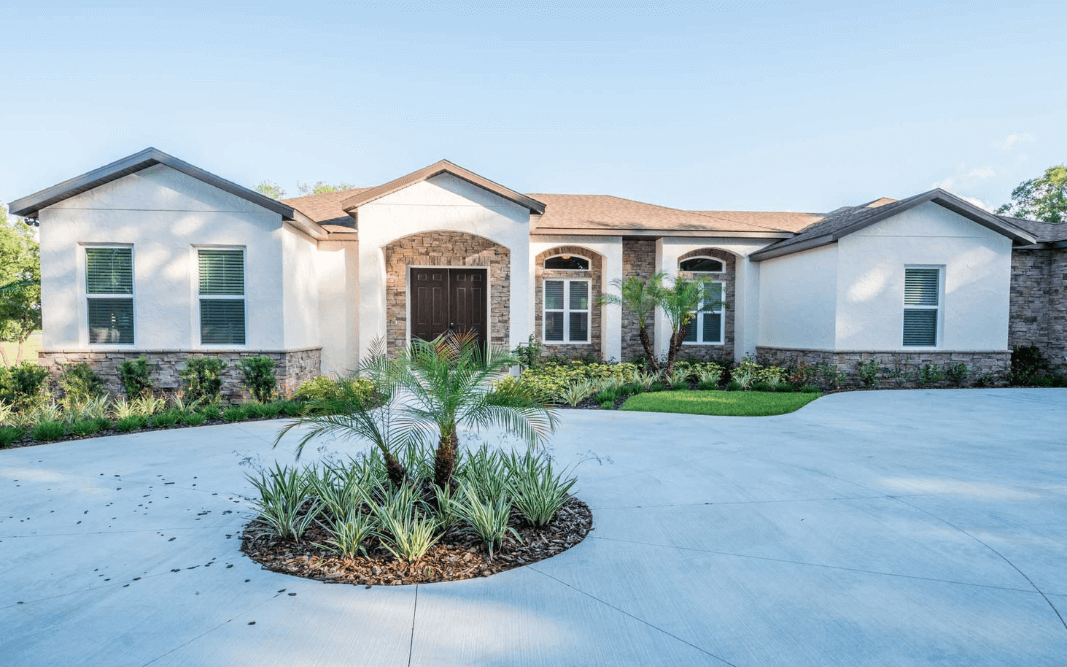 Exterior view of a custom-built home with stone accents, showcasing Bridgethorn Construction’s residential building expertise in Clermont, FL.